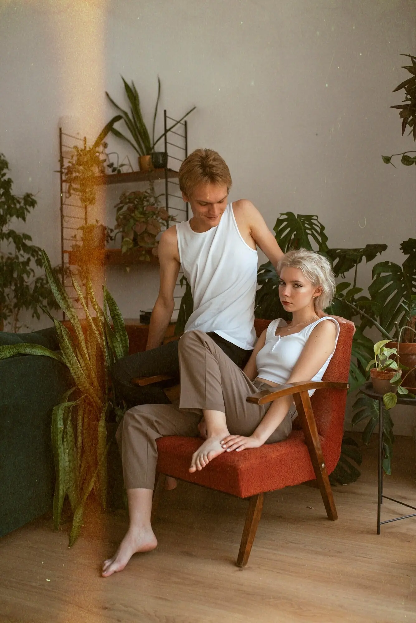 Ganzkörperaufnahme eines posierenden Paares in Innenräumen.